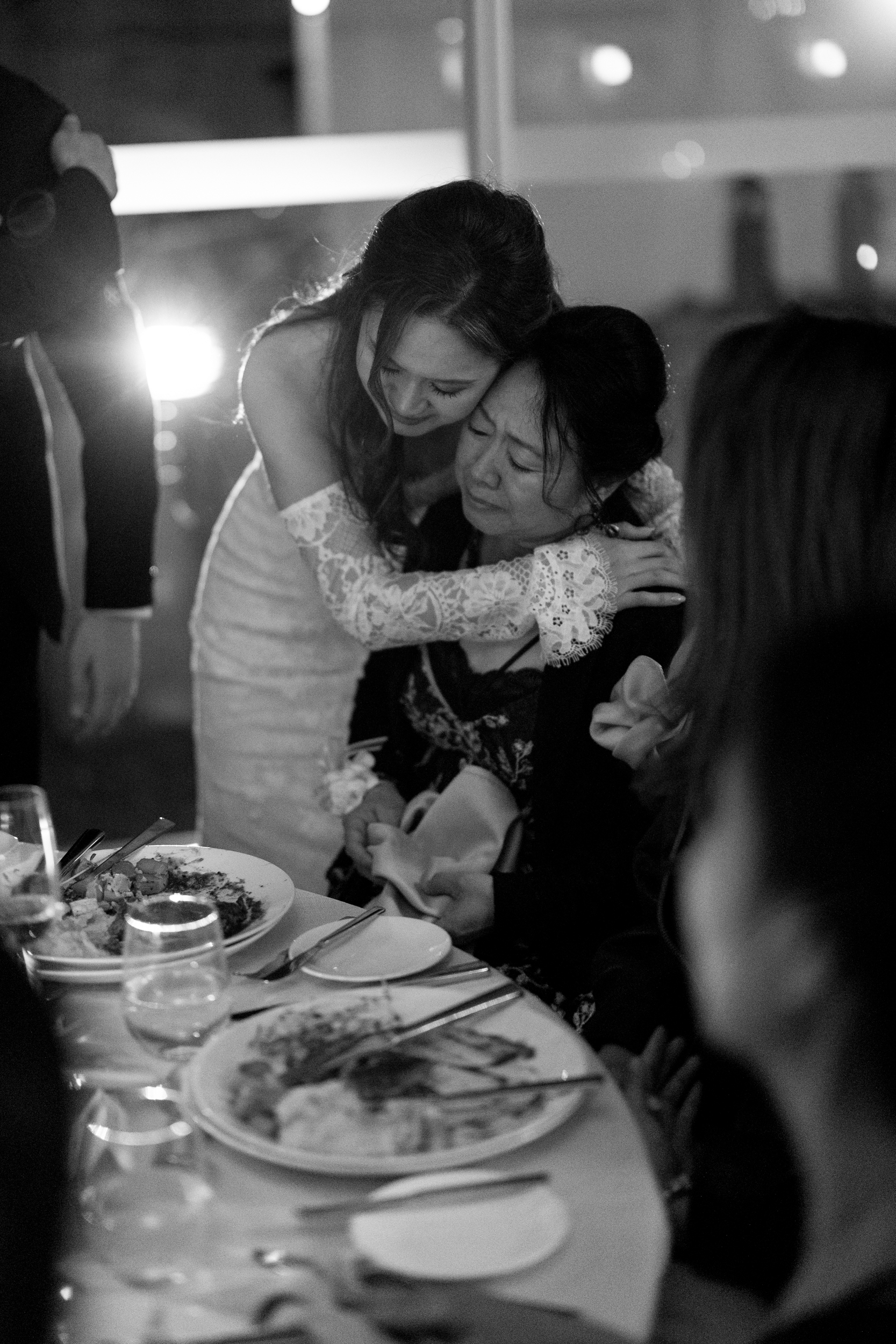 Bride hugging mom at reception